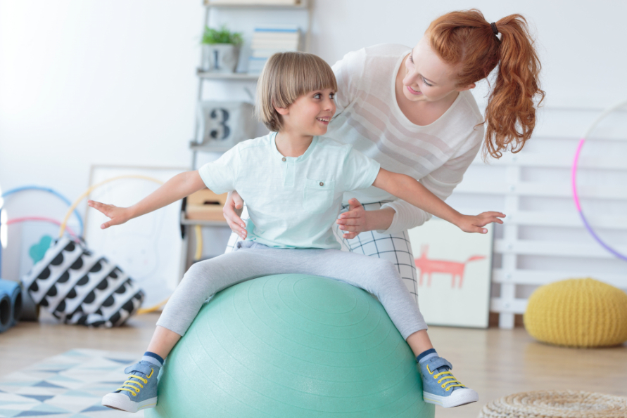 Child developing motor and daily living skills through occupational therapy