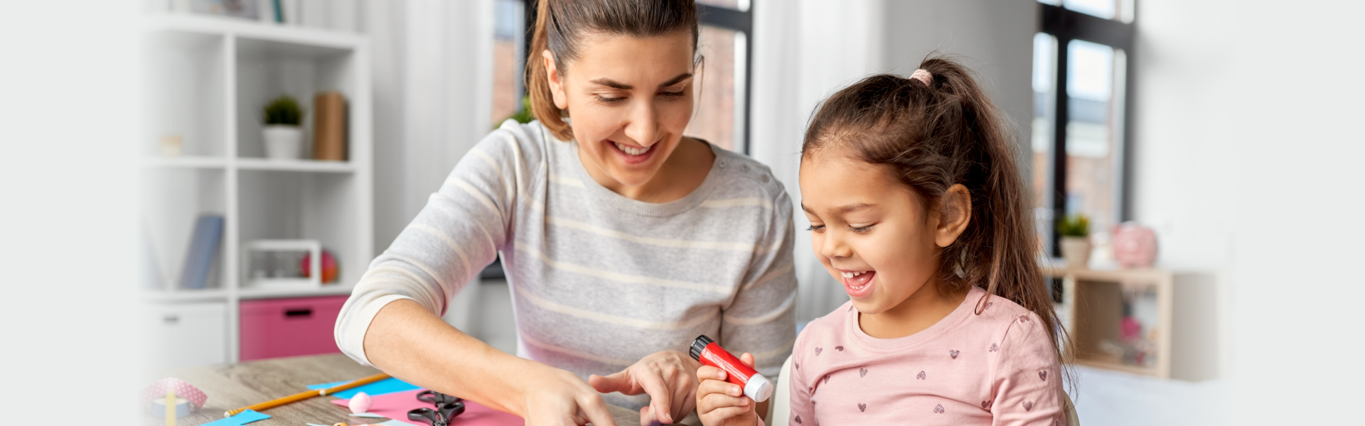 mother spending time with her little daughter with glue